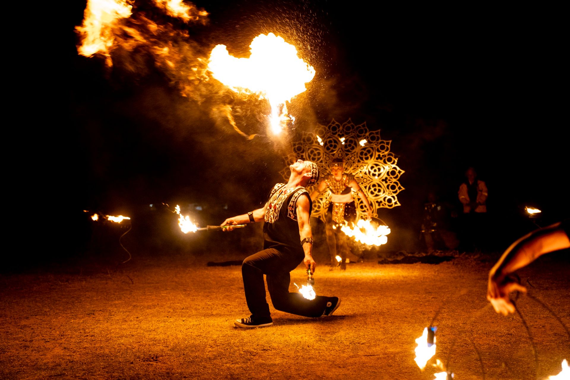 A fire dancer at night, spinning flames