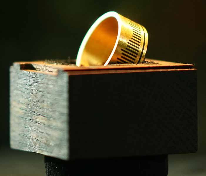 A ring of pure gold on a wooden block