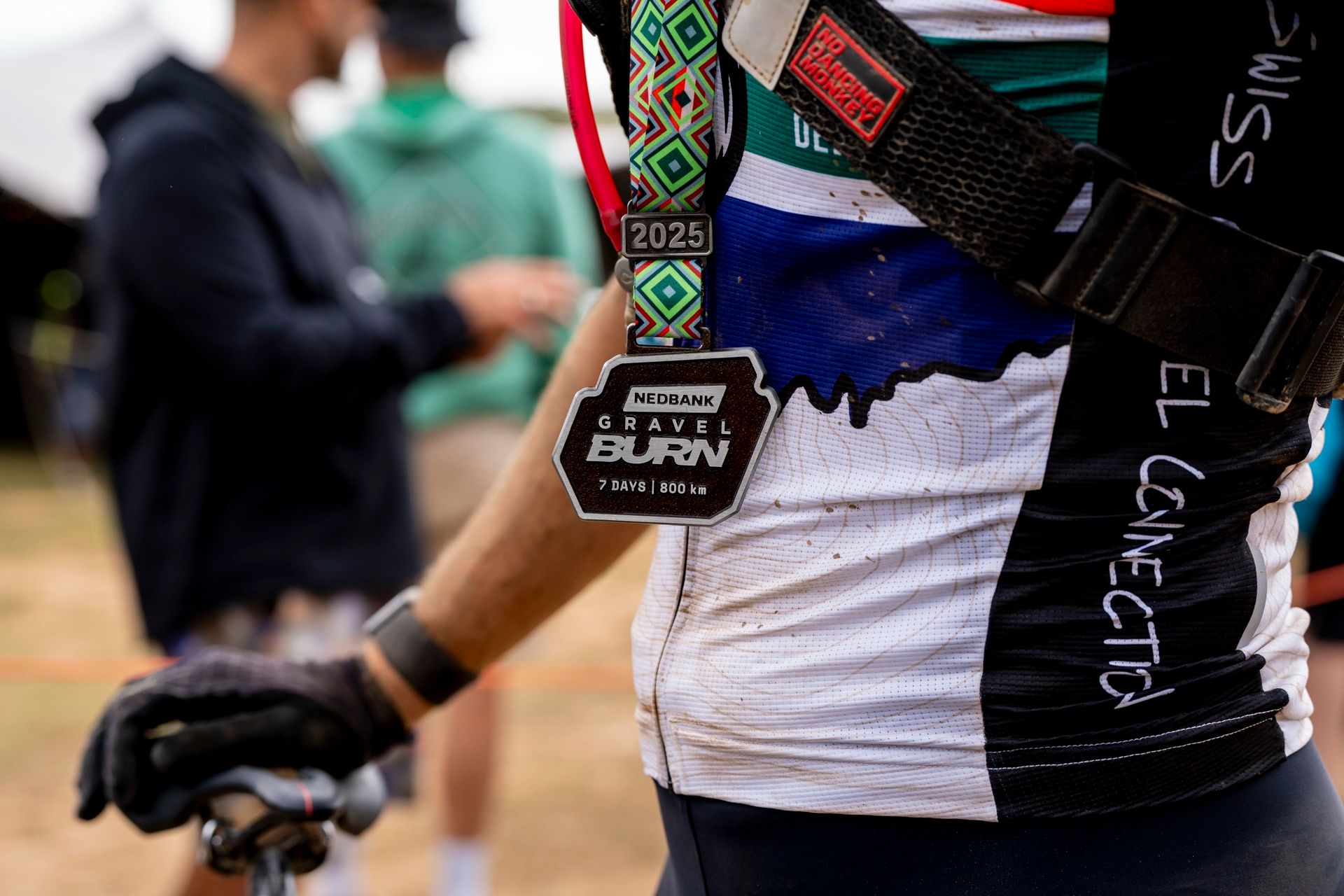A finisher medal hanging around a rider’s neck