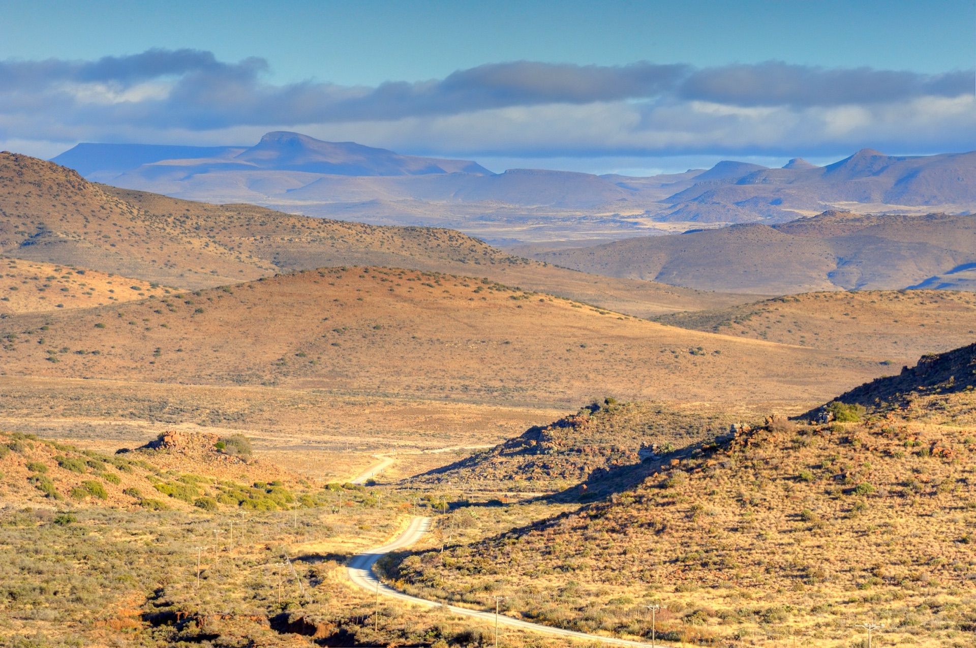 The Sneeuberg foothills: folded golden hills and valleys under a blue sky